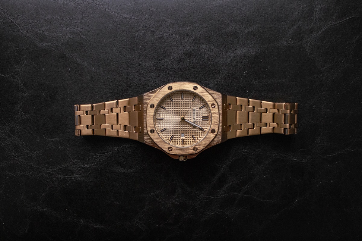 Gold luxury wristwatch on a dark background